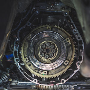 A close-up view of a car's transmission and gears from underneath the vehicle.